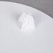 A Wilton white plastic cake separator plate on a white plate.