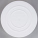 A white plastic Wilton cake separator plate with text on it.