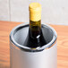 An American Metalcraft silver acrylic wine cooler holding a bottle of wine.