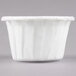 A close up of a Solo white paper souffle cup.