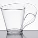 A clear plastic Fineline Tiny Temptations cup with a curved handle.