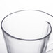 A clear plastic cup with a handle.