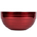 A close-up of a Dazzle Red Vollrath double wall metal bowl with a silver rim.