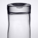 A close-up of a Libbey customizable beverage glass filled with water.