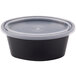 A Pactiv Newspring black oval souffle container with a clear lid.