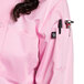 A woman wearing a light pink Uncommon Chef long sleeve chef coat with a mesh back.