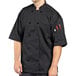 A man wearing a black Uncommon Chef Montego Pro Vent chef coat.