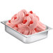 A metal pan of pink ice cream flavored with Fabbri Raspberry Flavoring.