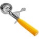 A silver metal scoop with a yellow handle.