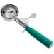 A green and silver metal ice cream scoop with a green handle.