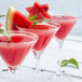 A group of glasses with red watermelon soft serve.