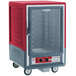 A red and silver Metro C5 heated holding cabinet with wheels.