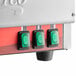 The green power switch of an Avantco vertical broiler with a white circle around the switch.