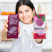 A woman holding up two Pitaya Foods organic dragon fruit smoothie packs.