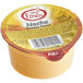 A yellow Muy Fresco container of nacho cheese sauce.