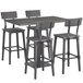 A Lancaster Table & Seating bar height table with 3 bar chairs with black seats.