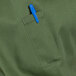 A blue pen in the pocket of a green apron with black webbing.