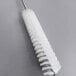 A white Rational drain cleaning brush with a long handle.