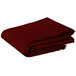 A stack of folded burgundy Intedge square table covers.