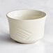 An Acopa ivory stoneware bouillon cup with a curved design and handle.