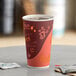 A close-up of a Choice coffee print paper hot cup on a table.
