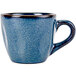 A close-up of a blue Tuxton China espresso cup with a handle.