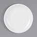 A white Tuxton porcelain saucer with a circle in the middle on a gray background.