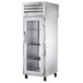 A True heated holding cabinet with glass doors and metal shelves.