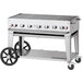 A Crown Verity stainless steel outdoor grill on a cart with black wheels.