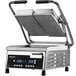 A Proluxe Vantage split lid panini grill on a counter with smooth plates open on both sides.