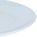 A close-up of a white Thunder Group oval melamine platter with a thin rim.