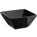 An Acopa glossy black square stoneware bowl on a counter.