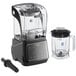 A black AvaMix commercial blender with a clear glass container and sound enclosure on top of a blender container with a handle.