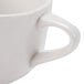 A close-up of a CAC Garden State white porcelain coffee mug with a handle.