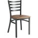 A Lancaster Table & Seating black metal ladder back chair with a wooden seat.
