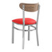 A Lancaster Table & Seating metal chair with a red vinyl seat.