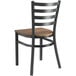 A Lancaster Table & Seating black metal chair with a vintage wood seat and ladder back.