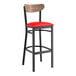 A black Lancaster Table & Seating bar stool with a red vinyl seat and vintage wood back.
