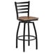 A Lancaster Table & Seating black ladder back bar stool with a vintage wood seat.