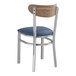 A Lancaster Table & Seating metal chair with a blue vinyl seat and wood back.