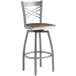 A Lancaster Table & Seating bar stool with a vintage wood seat and metal frame.
