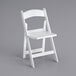 A close up of a white Lancaster Table & Seating folding chair with a slatted seat.