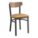A Lancaster Table & Seating Boomerang Series black chair with a tan seat.