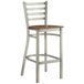 A Lancaster Table & Seating metal bar stool with a wooden seat.