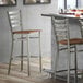A Lancaster Table & Seating Ladder Back Bar Stool with a Vintage Wood Seat.