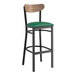 A Lancaster Table & Seating bar stool with a green vinyl seat and black frame.