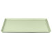 A white rectangular Cambro dietary tray with a light green border.