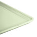 A close up of a Cambro Key Lime fiberglass dietary tray with a white surface.