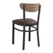 A Lancaster Table & Seating Boomerang Series black chair with dark brown vinyl and vintage wood back.