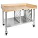 A John Boos wood top baker's table with stainless steel base and undershelf on wheels.